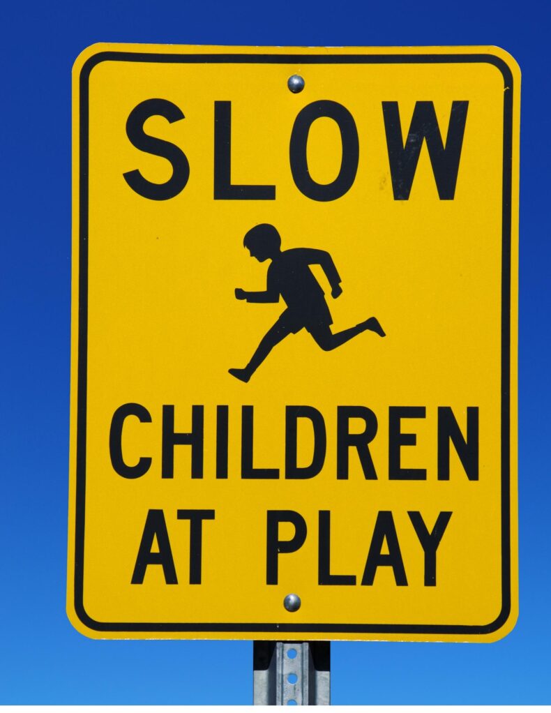 Slow Children At Playing Road Signs